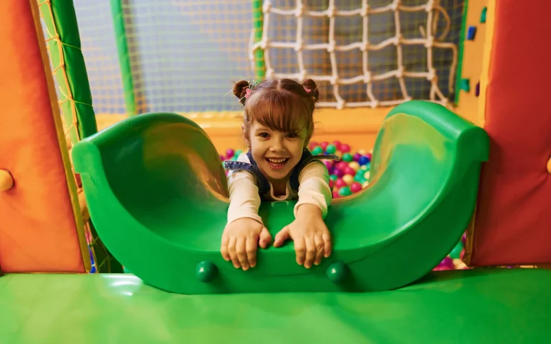 happy-girl-posing-on-colorful-indoor-playset-2026-01-08-23-36-10-utc