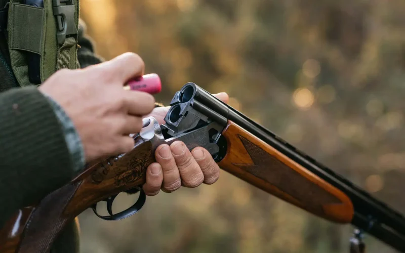 hunter-loading-a-double-barreled-shotgun-in-woods-2026-03-17-21-35-36-utc